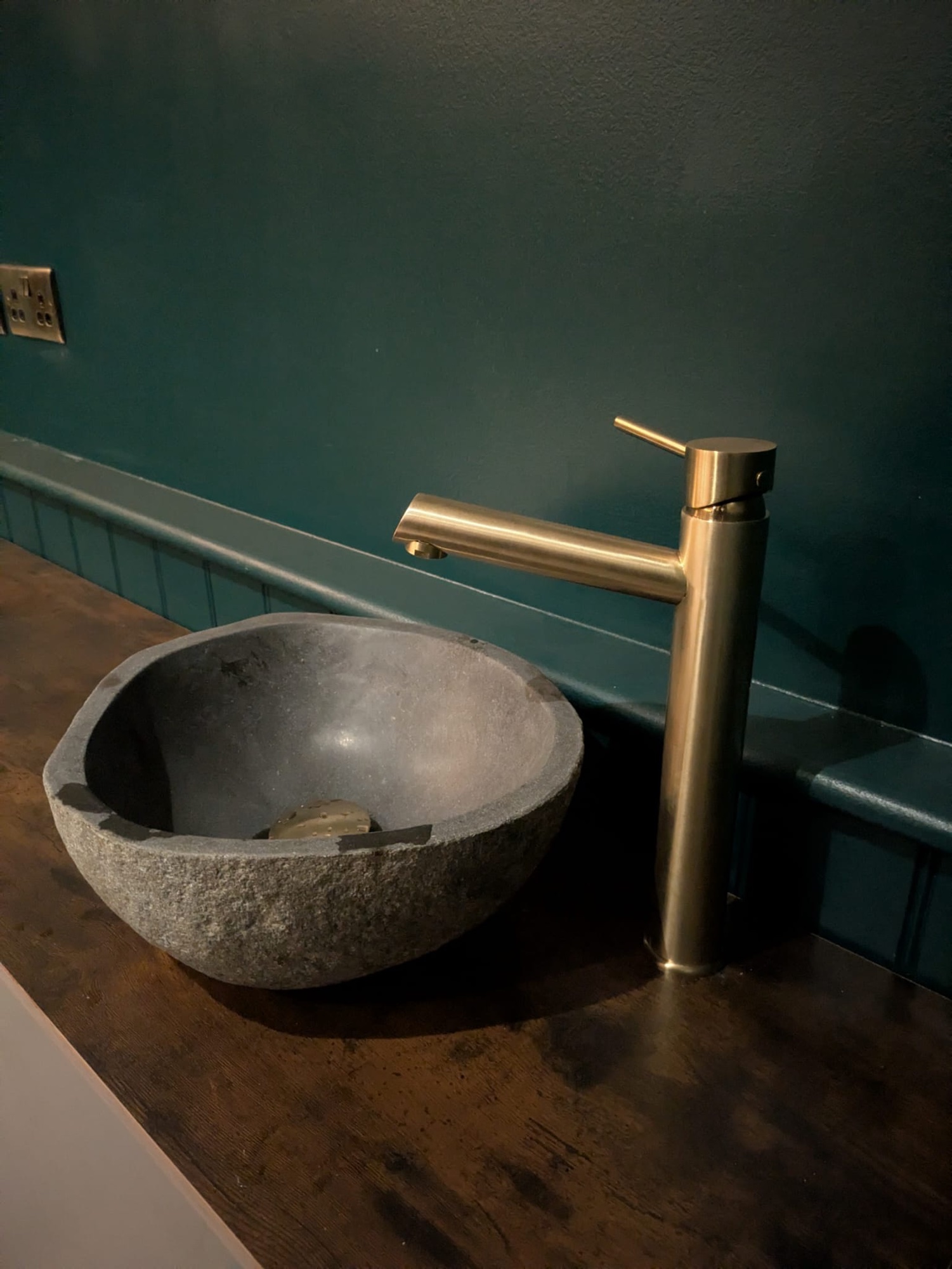 Bespoke vanity with stone vessel basin and brass tap by Cover It Building
