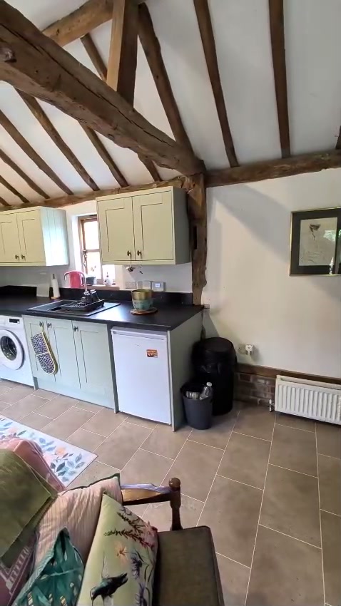 Fitted shaker kitchen with oak beams and vaulted ceiling by Cover It Building